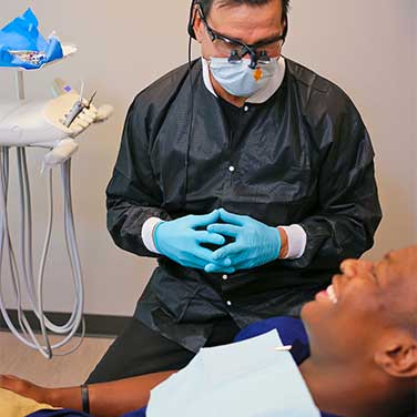 Dr. Gardiner chairside with a patient