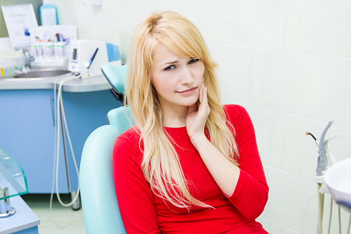 Patient holding jaw at Singing River Dentistry in Athens, AL