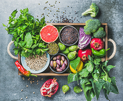 tray of healthy fruits, vegetables, herbs, seeds and nuts