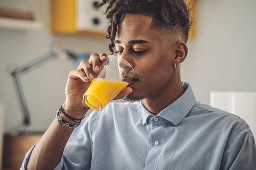 Man drinking orange juice