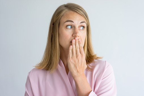 Woman holding her bad breath before appointment at Singing River Dentistry in Muscle Shoals, AL