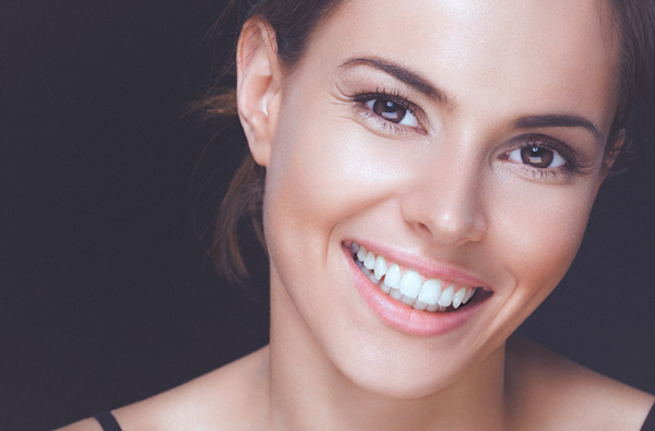 Woman smiling with perfect teeth at Singing River Dentistry in Alabama