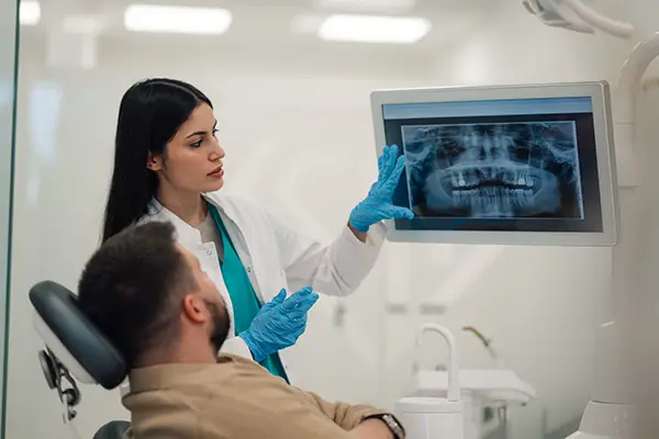 Dentist showing patient dental x-ray